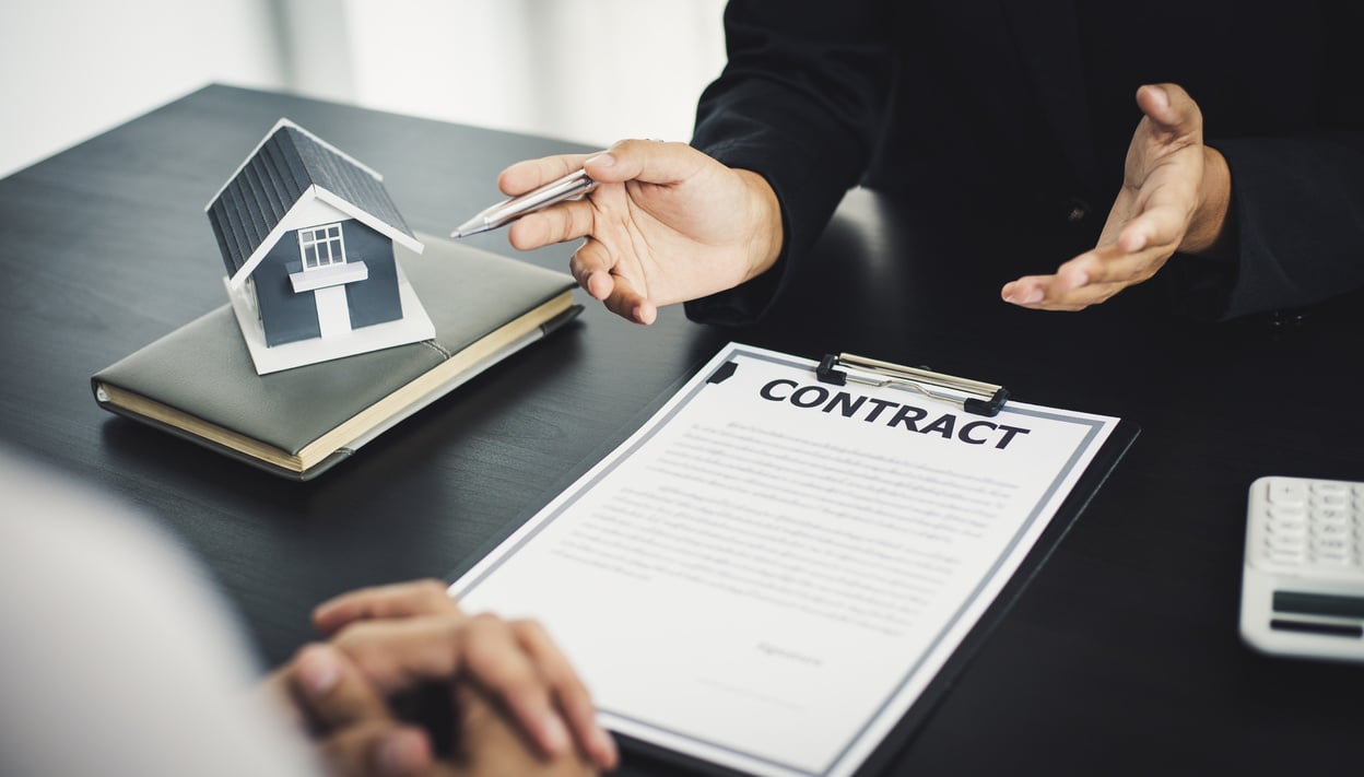 Real Estate Agent Showing Contract to Client